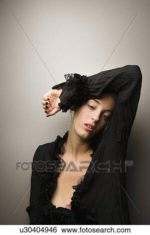 Stock Photograph - Attractive Caucasian woman with arm over head.. Fotosearch