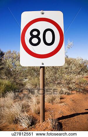 Stock Image - Australian kilometer per hour speed limit sign by rural dirt road. Fotosearch