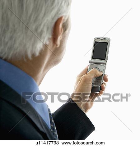 Back view of middle aged man looking at cell phone View Large Photo Image Stock Photo - Back view of middle aged man looking at cell phone. Fotosearch