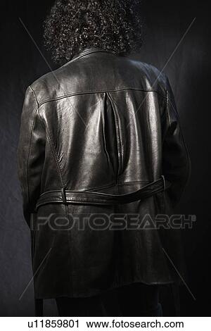 Back view of woman with curly hair wearing black leather jacket View Large Photo Image Stock Image - Back view of woman with curly hair wearing black leather jacket. Fotosearch