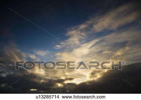 Picture - Backlit clouds in blue sky. Fotosearch
