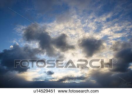 Backlit clouds in blue sky. View Large Photo Image Stock Image - Backlit clouds in blue sky.. Fotosearch