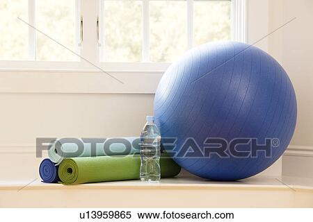 Balance ball, exercise mats and bottled water at gym by window View Large Photo Image Stock Photography - Balance ball, exercise mats and bottled water at gym by window. Fotosearch
