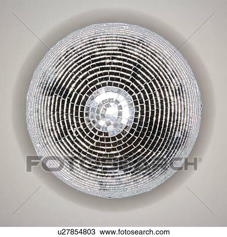 Stock Image - Below view of mirrored disco ball hanging from ceiling. Fotosearch