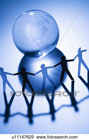 Black and white cutout paper people standing around Earth globe holding hands View Large Photo Image Stock Photo - Black and white cutout paper people standing around Earth globe holding hands. Fotosearch