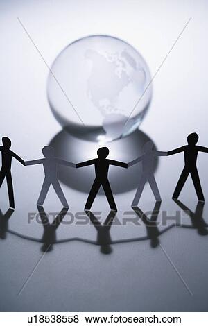 Stock Photo - Black and white cutout paper people standing aroung Earth globe holding hands.. Fotosearch