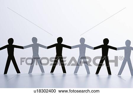 Stock Image - Black and white paper cutout men standing holding hands together. Fotosearch