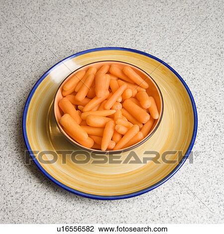 Bowl of carrots on counter View Large Photo Image Stock Image - Bowl of carrots on counter. Fotosearch
