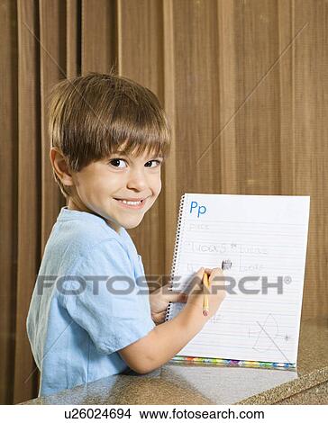 Boy holding up homework View Large Photo Image Picture - Boy holding up homework. Fotosearch
