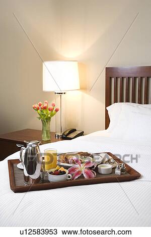 Breakfast tray laying on white bed in upscale hotel View Large Photo Image Stock Image - Breakfast tray laying on white bed in upscale hotel. Fotosearch