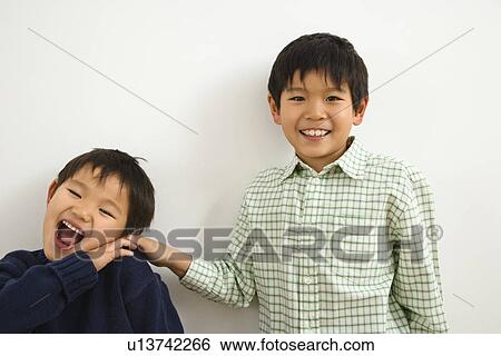 Stock Photograph - Brothers playing and laughing. Fotosearch