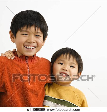 Stock Photo - Brothers with arms around each other smiling.. Fotosearch