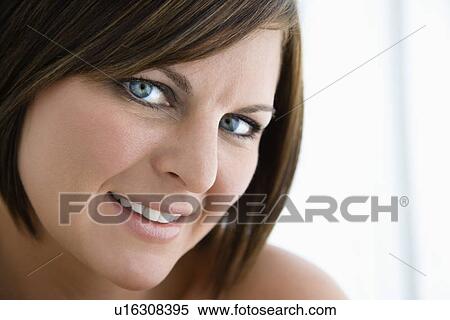 Stock Photography - Brunette woman smiling at viewer. Fotosearch