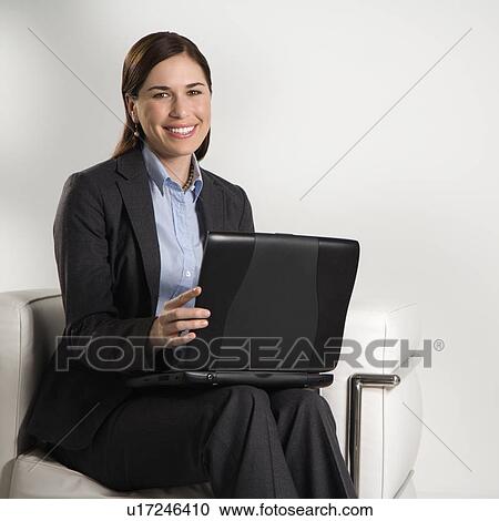 Business woman sitting working on laptop View Large Photo Image Stock Image - Business woman sitting working on laptop. Fotosearch