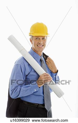 Businessman holding blueprints and wearing hard hat View Large Photo Image Stock Photo - Businessman holding blueprints and wearing hard hat. Fotosearch