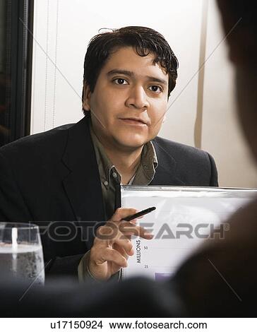 Businessman in meeting with charts View Large Photo Image Picture - Businessman in meeting with charts. Fotosearch