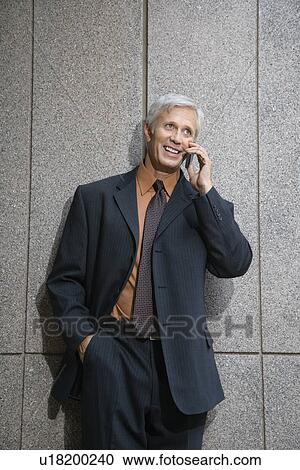 Businessman on cell phone smiling View Large Photo Image Stock Image - Businessman on cell phone smiling. Fotosearch