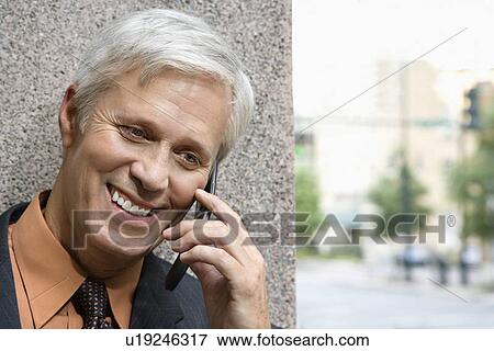 Stock Photo - Businessman talking on phone. Fotosearch