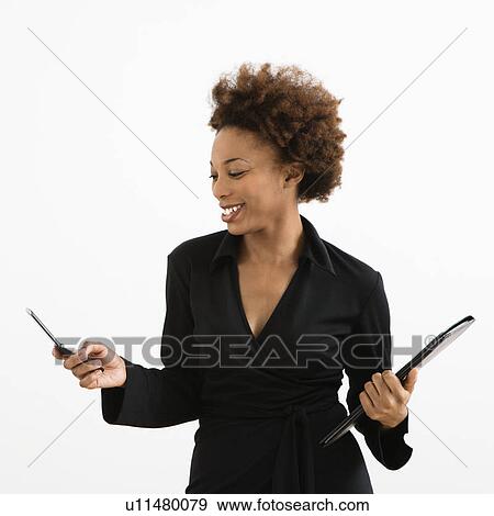 Businesswoman looking at cellphone smiling against white background. View Large Photo Image Stock Photo - Businesswoman looking at cellphone smiling against white background.. Fotosearch