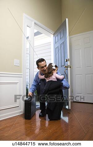 Caucasian businessman at open door with briefcase hugging daughter. View Large Photo Image Stock Photography - Caucasian businessman at open door with briefcase hugging daughter.. Fotosearch
