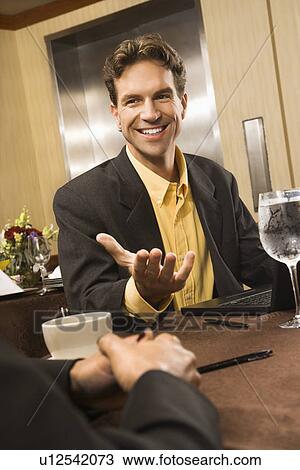 Caucasian businessman gesturing during meeting. View Large Photo Image Stock Image - Caucasian businessman gesturing during meeting.. Fotosearch