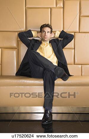 Picture - Caucasian businessman with hands behind head rolling eyes.. Fotosearch