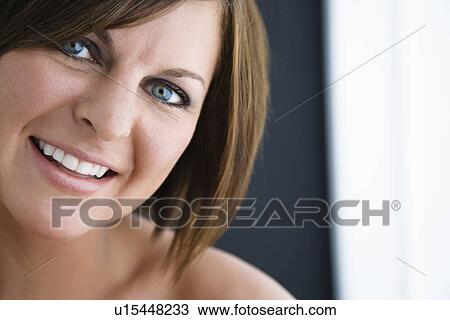 Stock Image - Caucasian mid adult brunette woman smiling at viewer.. Fotosearch