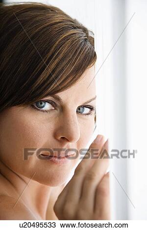 Stock Image - Caucasian mid adult brunette woman looking at viewer.. Fotosearch