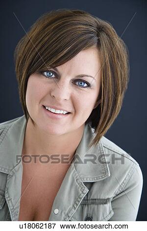 Stock Photo - Caucasian mid adult brunette woman smiling at viewer.. Fotosearch