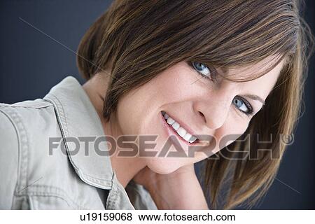 Stock Photo - Caucasian mid adult brunette woman smiling at viewer.. Fotosearch