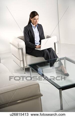 Caucasian mid adult professional business woman sitting in modern office working on laptop. View Large Photo Image Stock Image - Caucasian mid adult professional business woman sitting in modern office working on laptop.. Fotosearch