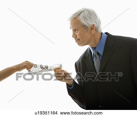 Picture - Caucasian middle aged businessman pulling one hundred dollar bill from woman.. Fotosearch