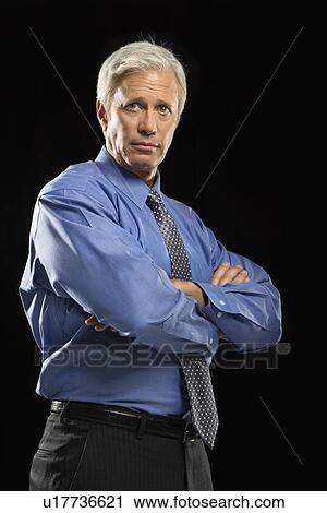 Caucasian middle aged businessman looking at viewer with arms crossed. View Large Photo Image Stock Image - Caucasian middle aged businessman looking at viewer with arms crossed.. Fotosearch