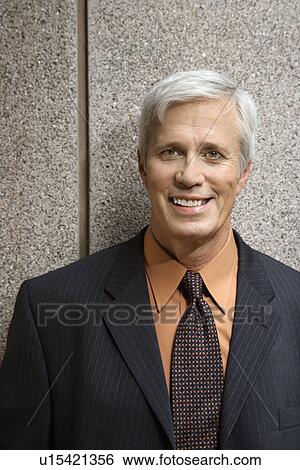 Stock Photograph - Caucasian middle aged businessman smiling at viewer.. Fotosearch