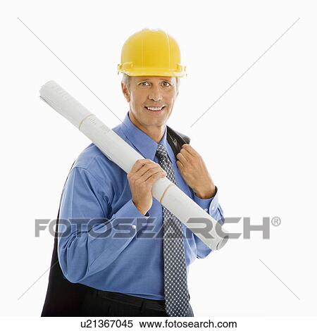 Stock Photography - Caucasian middle aged businessman holding blueprints and wearing hard hat.. Fotosearch