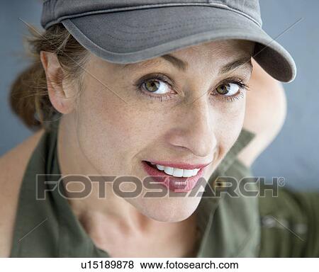 Stock Photo - Caucasian woman wearing hat smiling at viewer.. Fotosearch