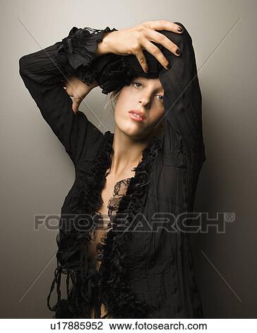 Caucasian woman with arms crossed over head looking at viewer. View Large Photo Image Stock Image - Caucasian woman with arms crossed over head looking at viewer.. Fotosearch
