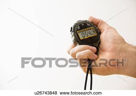 Stock Photo - Close-up of hand holding stopwatch. Fotosearch