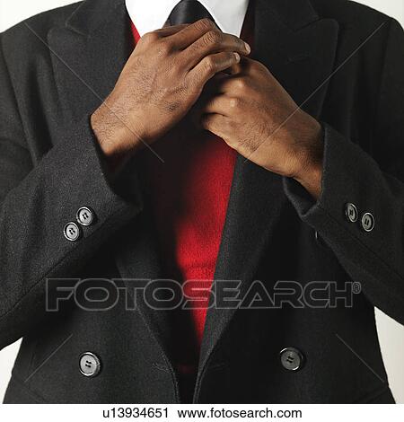 Close up of man fixing his necktie View Large Photo Image Stock Image - Close up of man fixing his necktie. Fotosearch