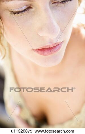 Stock Photography - Close-up portrait of serious Caucasian young adult female.. Fotosearch