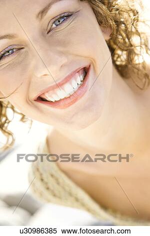Stock Photography - Close-up portrait of smiling Caucasian young adult female.. Fotosearch