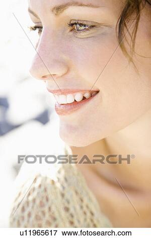 Stock Photo - Close-up portrait of smiling female. Fotosearch