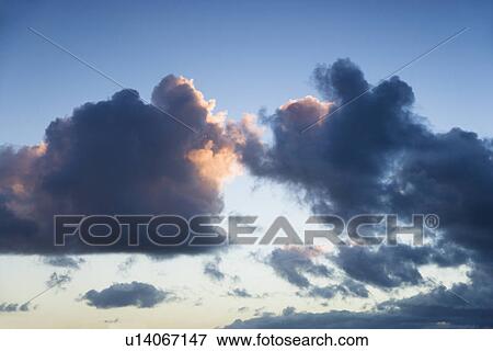 Stock Photo - Colorful cumulus cloud formation in sky.. Fotosearch
