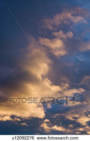 Stock Photograph - Colorful cumulus clouds in sky. Fotosearch