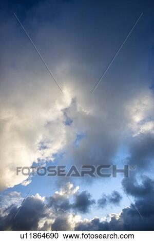 Stock Image - Cumulus clouds in blue sky. Fotosearch