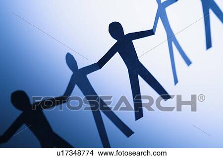 Picture - Cutout paper men standing holding hands. Fotosearch