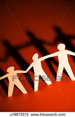 Stock Image - Cutout paper men standing holding hands.. Fotosearch