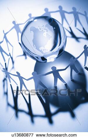 Stock Photo - Cutout paper people standing around globe holding hands. Fotosearch