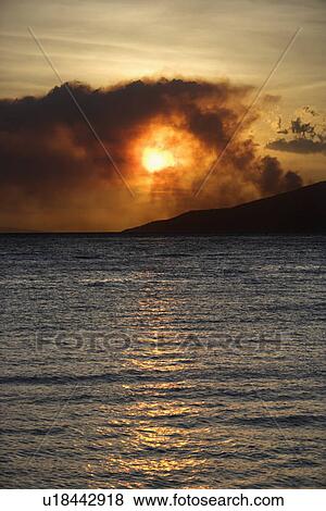 Dark clouds at sunset over water View Large Photo Image Stock Photo - Dark clouds at sunset over water. Fotosearch
