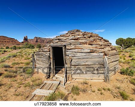 Stock Photo - Desert landscape with rustic log cabin shelter. Fotosearch